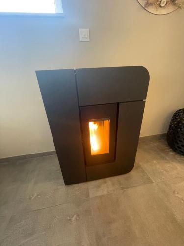 a fireplace in the corner of a room at le temps d'une retrouvaille in Jalhay