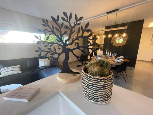 a living room with a tree on a table at le temps d'une retrouvaille in Jalhay