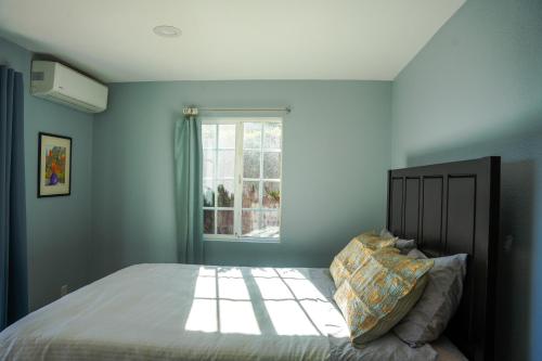 a bedroom with a bed and a window at Relaxing Home With SF Bay View in Millbrae