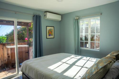 a bedroom with a bed and a window at Relaxing Home With SF Bay View in Millbrae