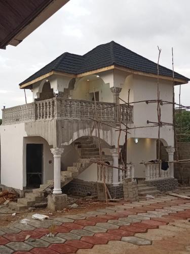 a house being constructed with a balcony and stairs at CIDMAT in Lakka