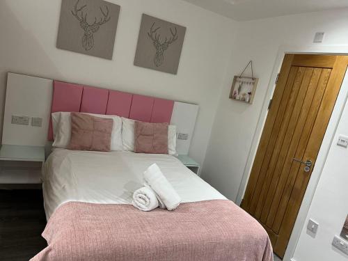 a bedroom with a large bed with two towels on it at Crosskeys Edinburgh in Edinburgh