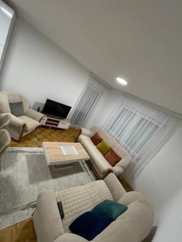 a living room with two couches and a table at Apartment in Gjilan in Gnjilane