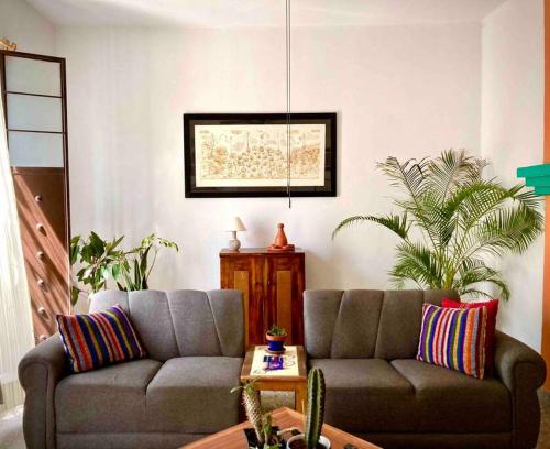a living room with a couch and a table at Casa Mera Mera in Oaxaca City