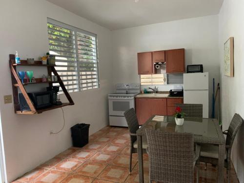 a kitchen with a table and a dining room at Million dollar view in Puerto Rico in Luquillo