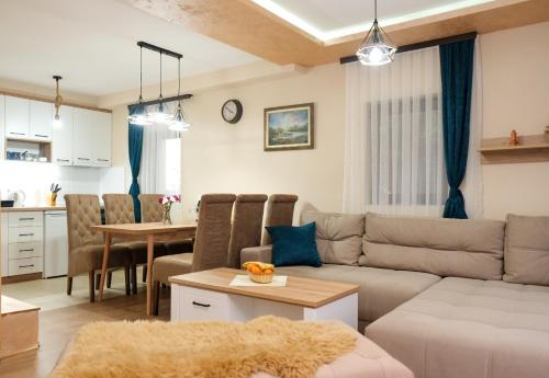 a living room with a couch and a table at Villa Zagorka and mountain houses A, M, D in Kopaonik