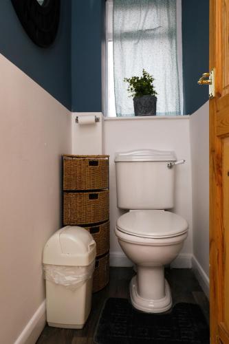 a bathroom with a toilet and a window at Harmony Haven - Amity Suite in Nottingham