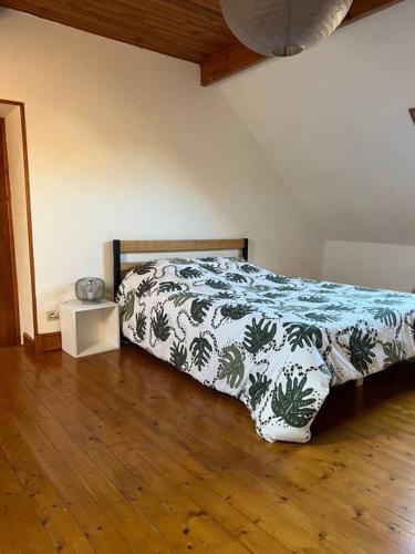 - une chambre avec un lit et une couette verte et blanche dans l'établissement Entre 2 caps, à Rinxent