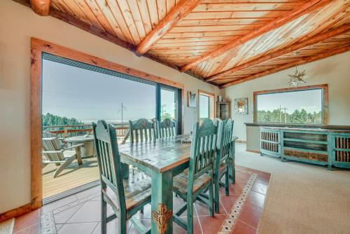a dining room with a table and chairs on a deck at Cloudcroft Cabin with View about 4 Mi to Ski Cloudcroft! in Cloudcroft