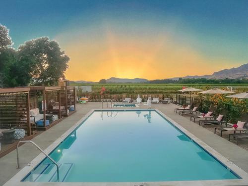 a large swimming pool with a rainbow in the background at Bann at Oak Knoll Napa in Napa