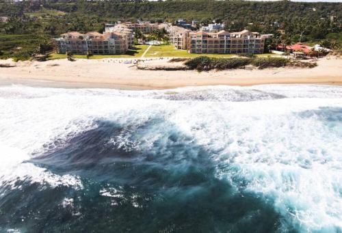 an aerial view of a beach and the ocean at Paradise Coast PR - Condo in Isabela