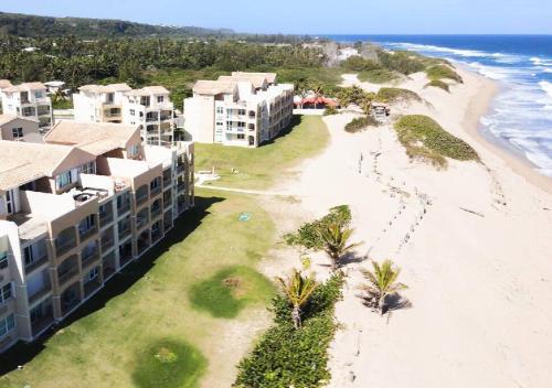 an aerial view of a beach and buildings at Paradise Coast PR - Condo in Isabela