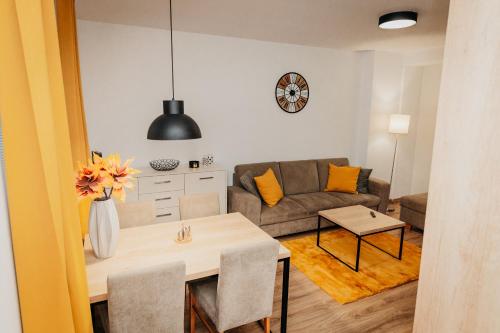 a living room with a table and a couch at Old Town city center apartment 2 - private parking included in Košice