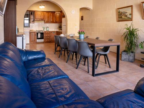 a kitchen and dining room with a table and chairs at Moonshine Villa in Nadur