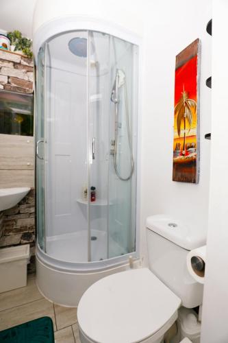 a bathroom with a toilet and a glass shower at Harmony Haven - Ocean Drive Suite in Nottingham