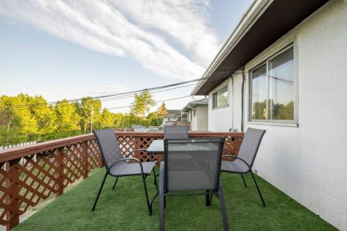 two chairs and a table on a balcony at Forth Street 2Bedroom Suite in Calgary