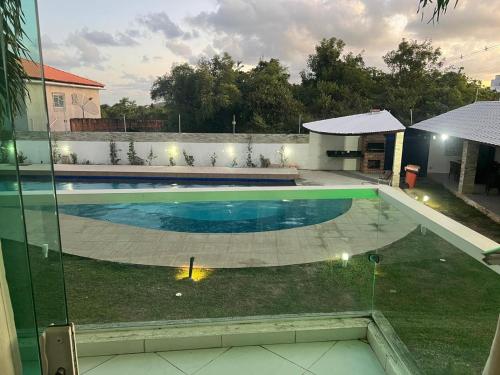 a swimming pool in the yard of a house at Mar e Sol Residencial em Jacuma PB in Conde