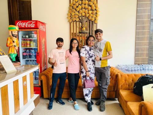 a group of people standing next to a coca cola machine at Avista Hotel in Amritsar