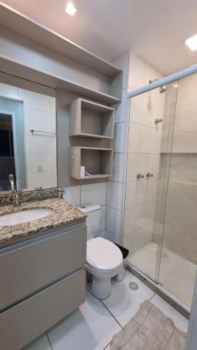 a bathroom with a toilet sink and a shower at Apartamento novo ao lado do shopping da ilha in São Luís