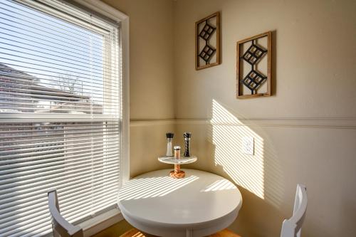 a white table and chair in a room with a window at Quaint Cedar Rapids Home, 4 Mi to Downtown! in Cedar Rapids