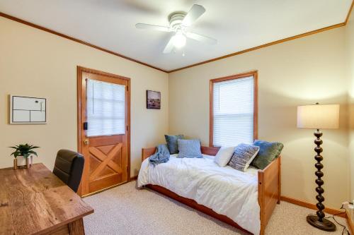 a bedroom with a bed and a ceiling fan at Quaint Cedar Rapids Home, 4 Mi to Downtown! in Cedar Rapids