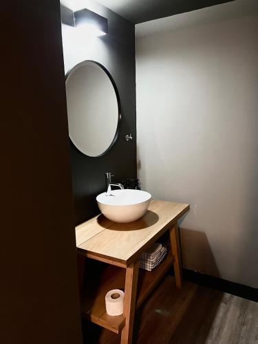 a bathroom with a sink and a mirror at The Lot Boutique in Lima