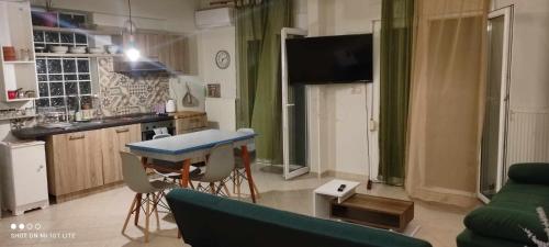 a kitchen and living room with a table and a couch at pylaia comfortable apartment 2 in Thessaloniki