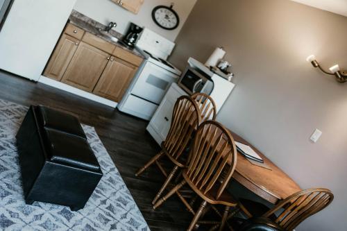 a kitchen with a table and chairs and a refrigerator at Page's Inn on Silva Bay in Gabriola