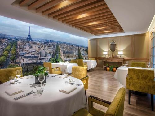 a restaurant with tables and a view of the eiffel tower at Sofitel Saigon Plaza in Ho Chi Minh City