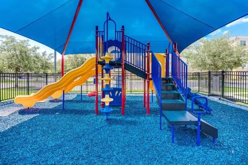 a playground with a slide in a park at Vista Cay Getaway Luxury Condo by Universal Orlando Rental in Orlando