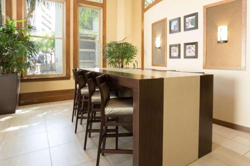 a bar in a room with chairs around it at Drury Inn & Suites San Antonio Riverwalk in San Antonio