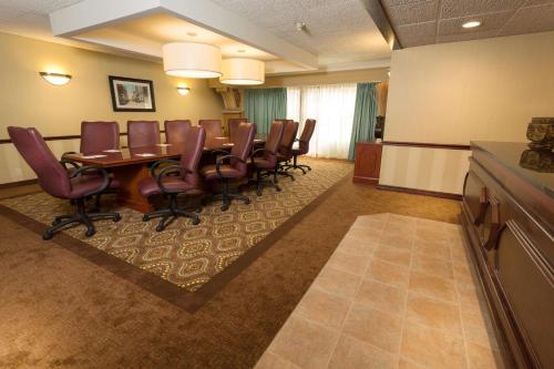a conference room with a long table and chairs at Pear Tree Inn St Louis Convention Center in Saint Louis