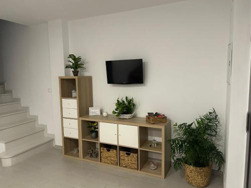 a living room with a tv on a wall at Balcon San Rafael in Córdoba