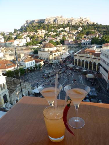 two cocktails on a table with a view of a city at A for Athens in Athens