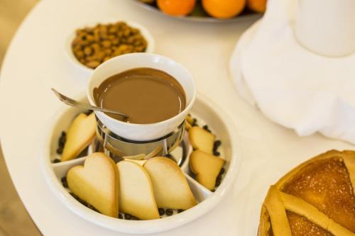 a bowl of food with a cup of chocolate at Hotel Italia in Siena