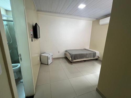 a hospital room with a bed and a toilet at Hotel Brasília - centro in Brasilia