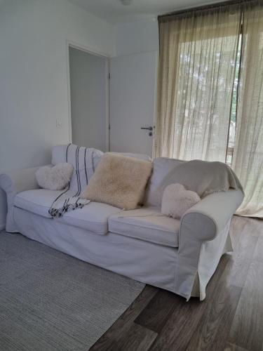 a white couch in a living room with a window at Villa93 in Villepinte