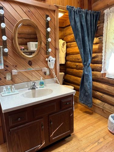 a bathroom with a sink in a log cabin at Justin Trails Resort in Sparta