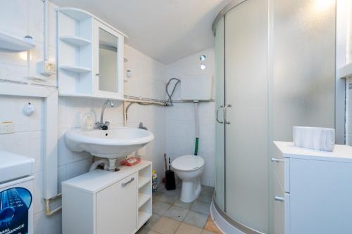 a bathroom with a sink and a toilet and a shower at Apartments by the sea Sveti Marko, Pag - 21654 in Pag