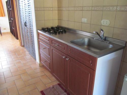 a kitchen with a sink and a stove at Marfi Inn in Cahuita