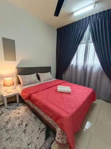 a bedroom with a red bed with a window at ER Homestay for Family Transit Nearby KLIA in Sepang