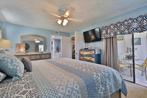 a bedroom with a bed and a ceiling fan at Sea Woods 3 Bedroom 2 Bath in New Smyrna Beach