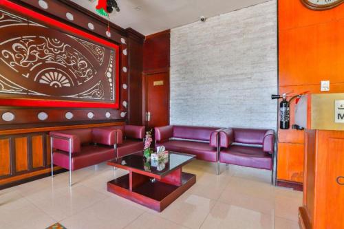 a living room with purple couches and a table at Grand PJ Hotel - Free Parking in Ras al Khaimah