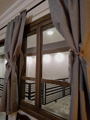 a window with a view of a balcony at Añoranza Hotel Boutique in Ciudad Hidalgo