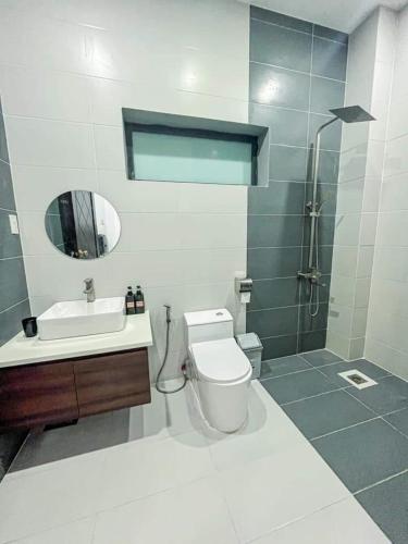 a bathroom with a toilet and a sink and a shower at River Hotel 5 in Long Xuyên