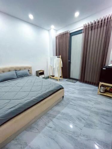 a bedroom with a bed with a marble floor at River Hotel 5 in Long Xuyên