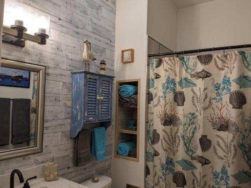 a bathroom with a shower curtain and a sink at Fish/Boat & Relax Resort Marina Gem on the water! in Naples