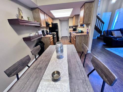 a kitchen with a wooden table and chairs in a room at The Cozy Townhouse WPAFB & WSU in Fairborn