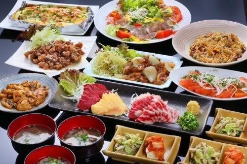 a table full of different types of food on plates at FARMSTAY miyuki-street "Goen" in Ukiha