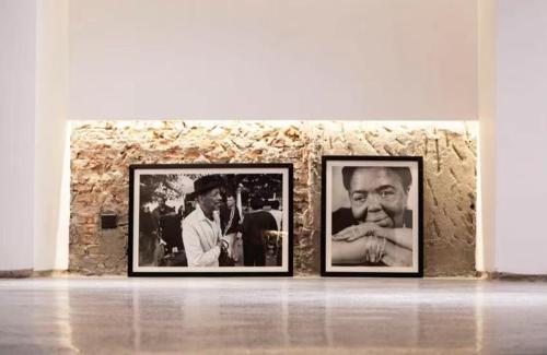 two framed photographs on a stone wall in a museum at Zhuhai Bei Shan Ju Art Hotel in Zhuhai
